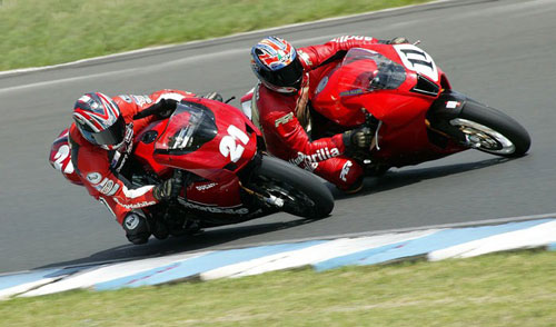 P.Martin Ducati 999s Australian Superbike Championship. Aprilia Factory Rider John Allen 'showing me around the corner'.